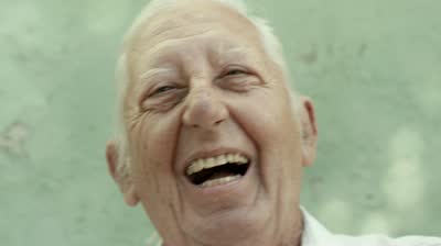 stock-footage-active-retired-people-portrait-of-three-old-male-friends-smiling-and-laughing-on-bench-in-public
